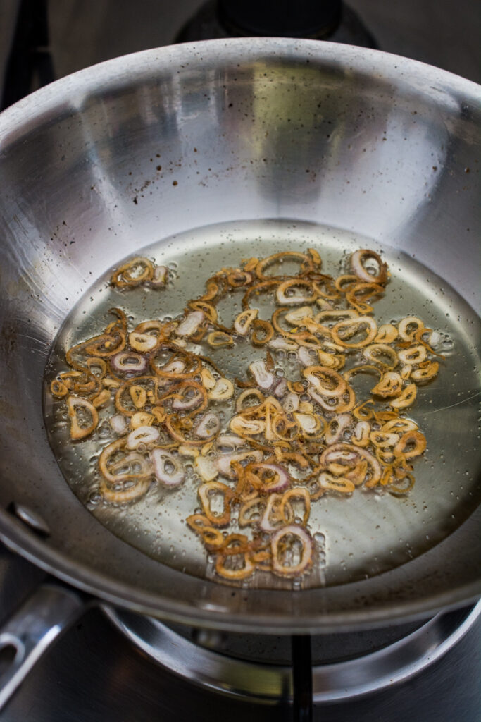 deep frying shallots in a pan 