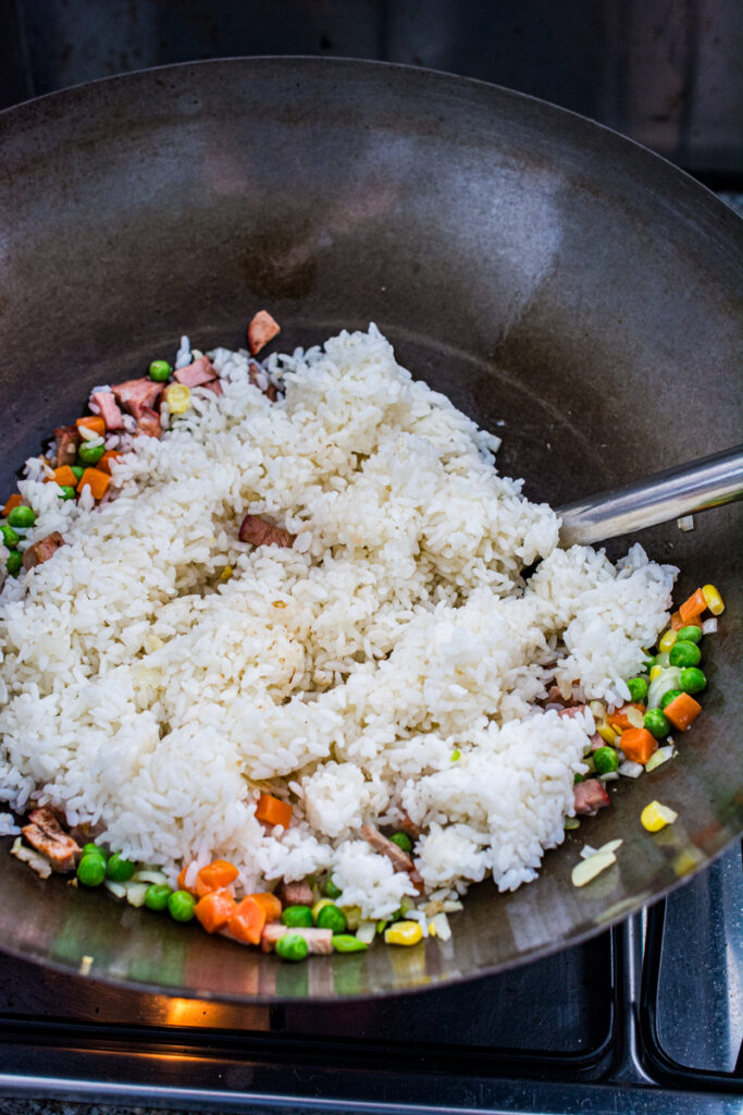 cooked rice and veggies in a wok