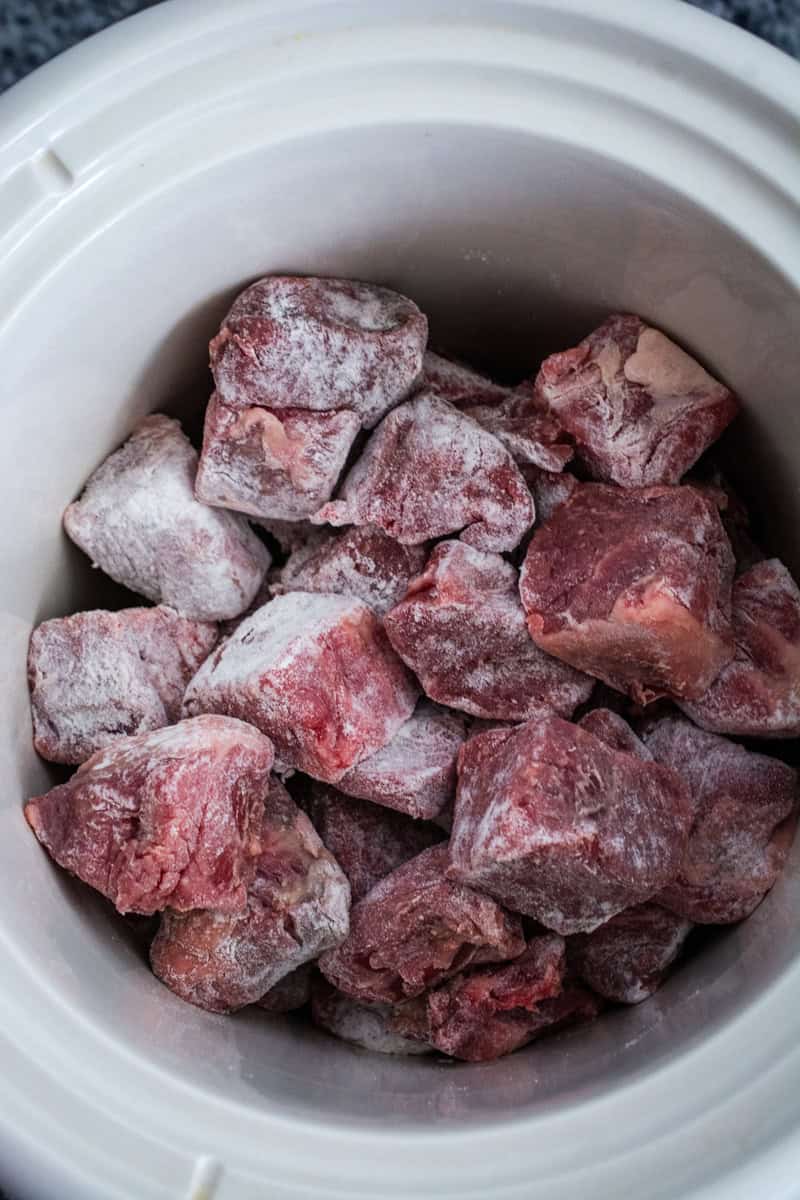 floured beef in a slow cooker